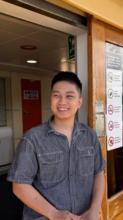 Tony Quang smiling, wearing a chambray shirt